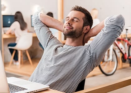 Man at office desk relaxing