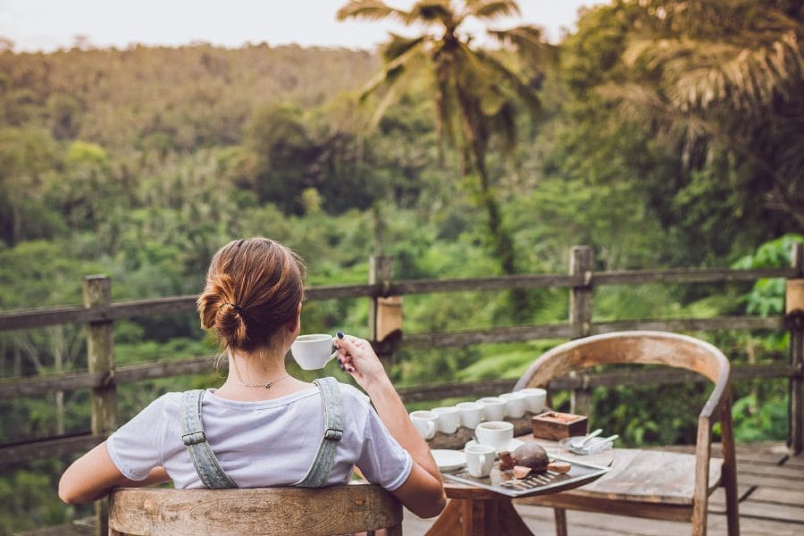 Woman drinking kava looking at the topical scenery